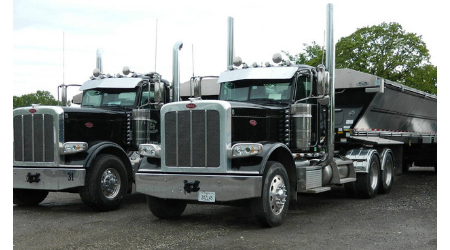 2 dump trucks parked